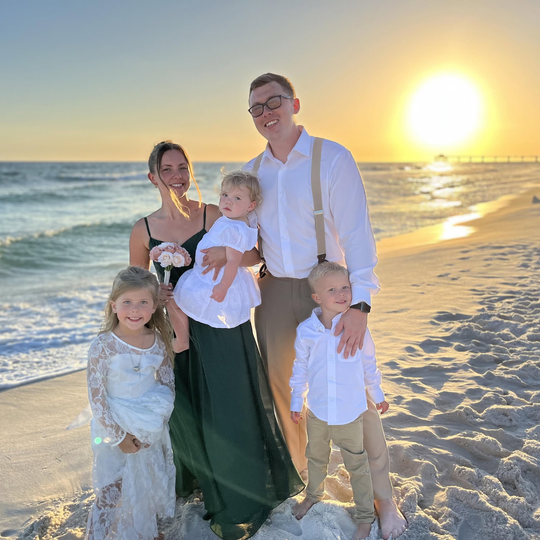 Tyler Smith, owner of MetroWebsites.com, with his family on the beach at sunset